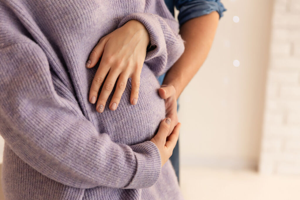 beautiful pregnancy of young family. pregnant woman and man. happy couple, wife and husband hugging tummy