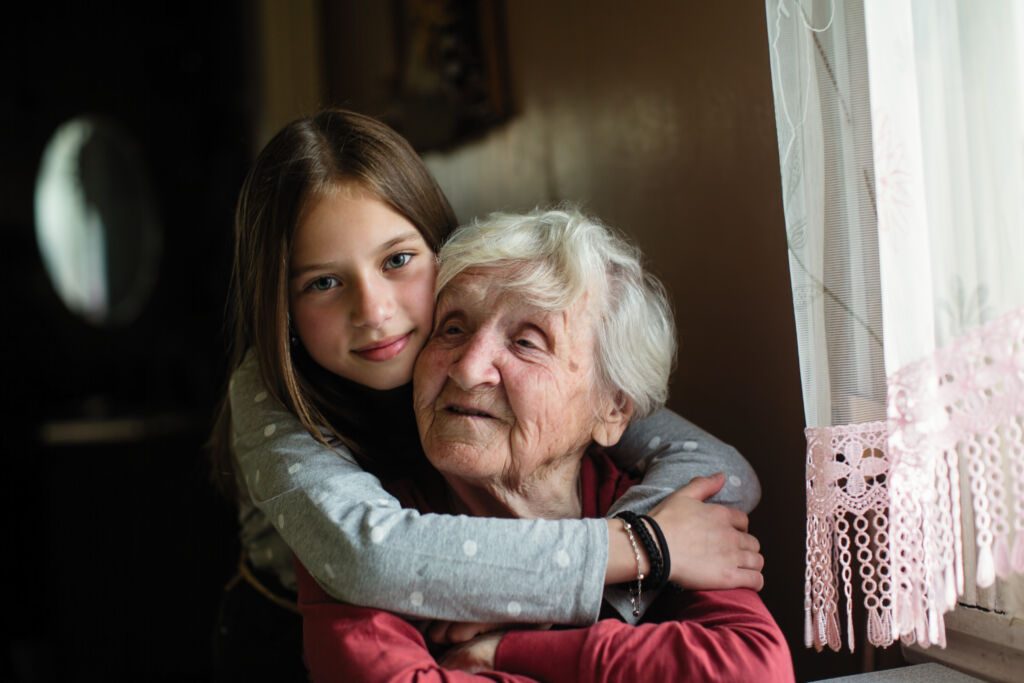 portrait of an elderly woman with her young granddaughter.