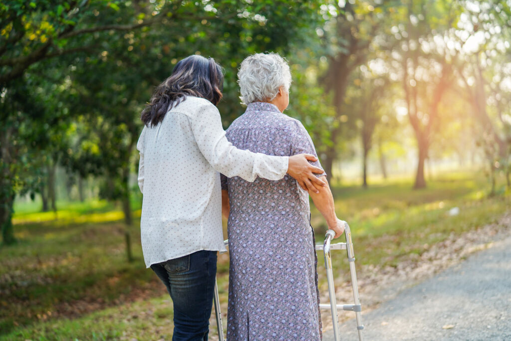 help and care asian senior or elderly old lady woman use walker