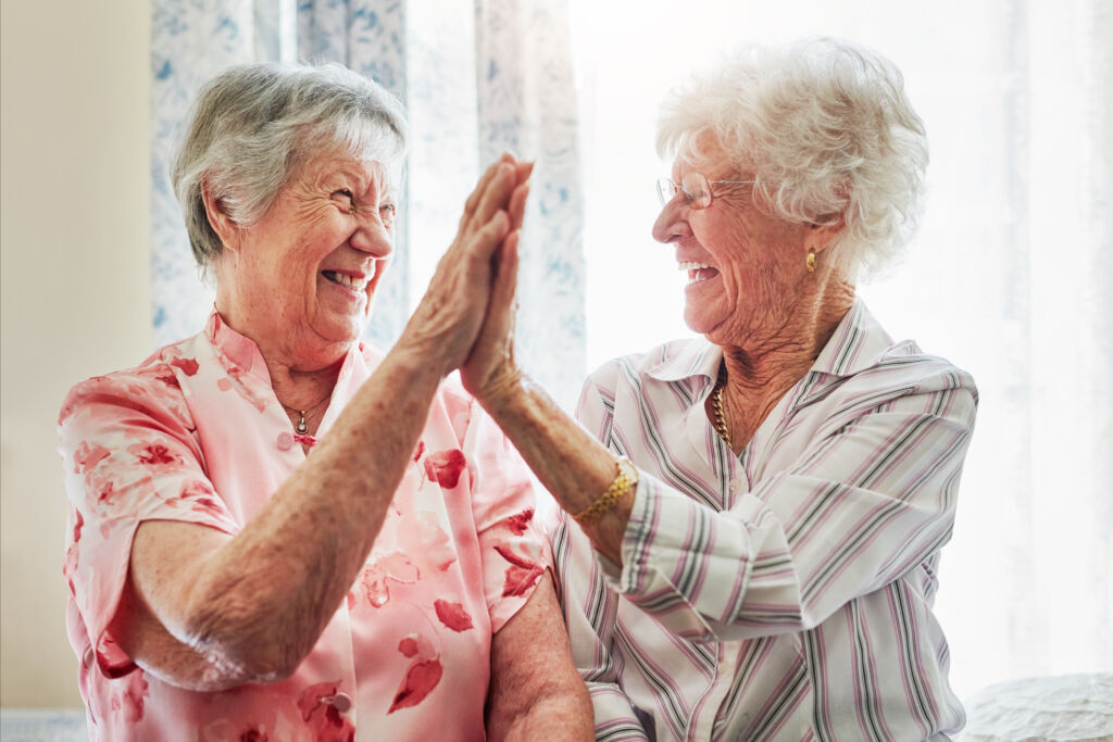 happy, love and senior women with a high five for care, retirement support and happiness. smile, team and elderly friends with excited gesture for solidarity or lifestyle in a nursing home together