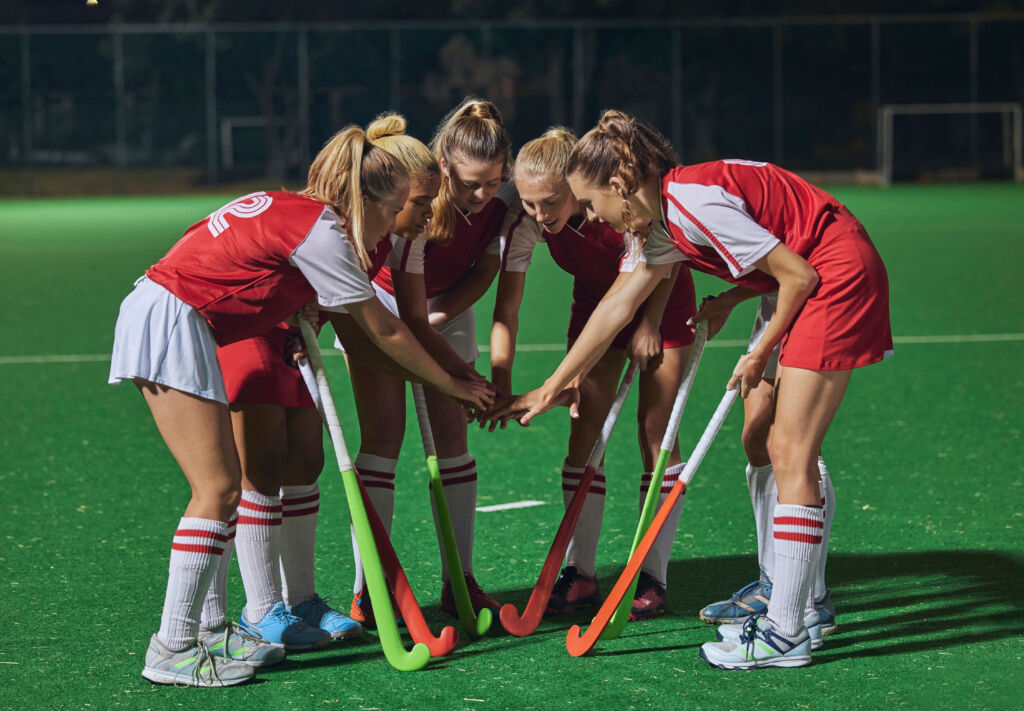 hockey, together hands and women teamwork, support or motivation for game, competition or training strategy communication. leadership, sports and group hand stack circle in target goal collaboration