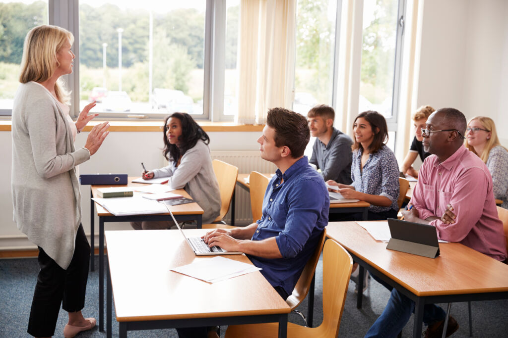 female tutor teaching class of mature students