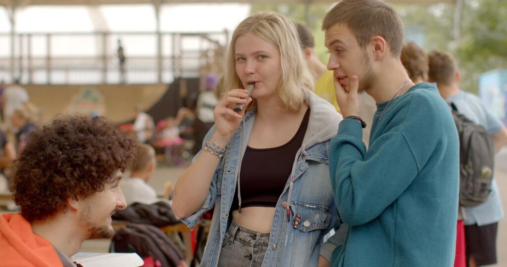portrait modern young people. vaping popular among youth alternative to smoking